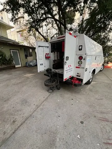 Magnet Plumbing service vehicle on-site for Grease Trap Cleaning in Surfside